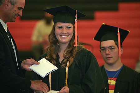 Brittani Clairmont receives her diloma as Daniel Clairmont waits in line.