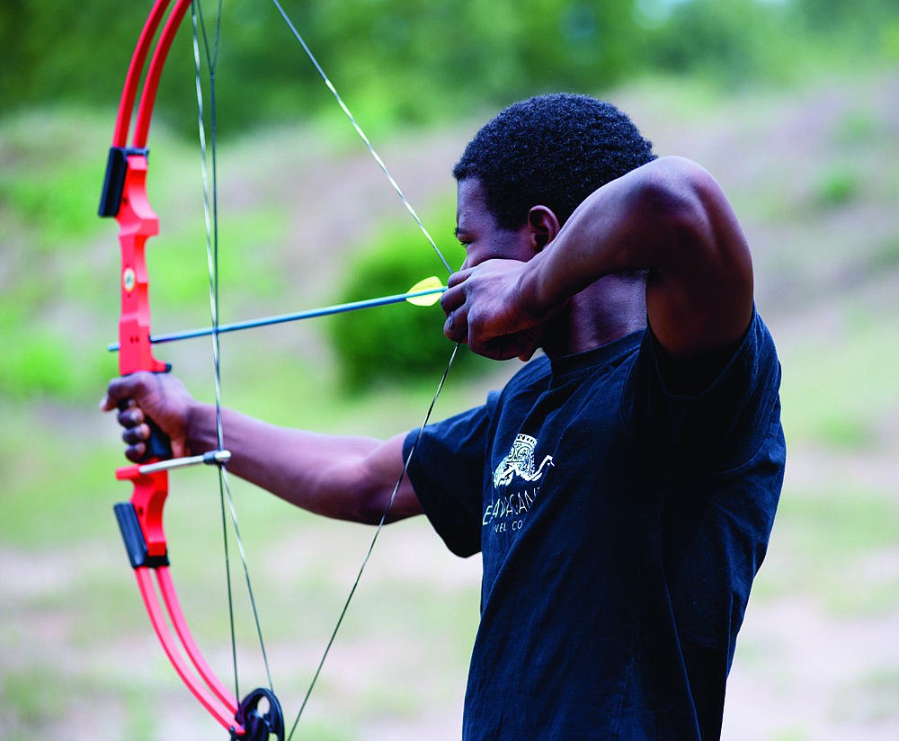 &lt;p&gt;Aaron Collins takes aim with a compound bow during the National Turkey Federation's Jake Shoot last Saturday at the Plains Trap Club.&lt;/p&gt;