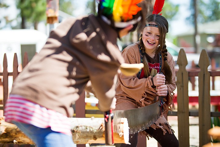 &lt;p&gt;Hali Harmon saws a portion of a log with a fellow fourth-grader at a station aimed at teaching logging practices of the past.&lt;/p&gt;