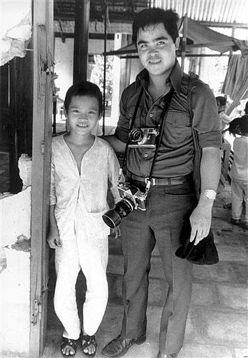 &lt;p&gt;In this 1973 file photo, Phan Thi Kim Phuc, left, is visited by Associated Press photographer Nick Ut at her home in Trang Bang, Vietnam. As a nine-year-old, Kim Phuc was the subject of a Pulitzer Prize-winning photo by Ut as she fled in pain from a misdirected napalm attack against her village by South Vietnamese planes in 1972. After taking the photograph, Ut came to the girl's aid and transported her to a hospital. (AP Photo/File)&lt;/p&gt;