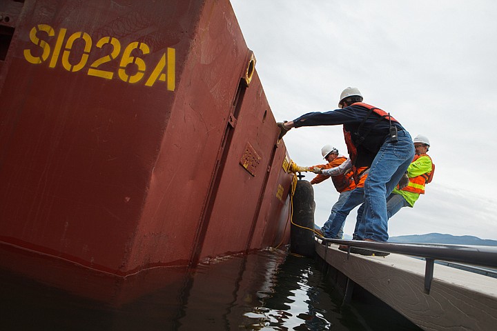 &lt;p&gt;Patrick Cote/Daily Inter Lake Envirocon workers secure a barge to the dock at City Beach. The barge is part of the dredging operation to clean up contaminated sediments, caused by a train derailing in 1989, in Mackinaw Bay. Wednesday, May 30, 2012 in Whitefish, Montana.&lt;/p&gt;