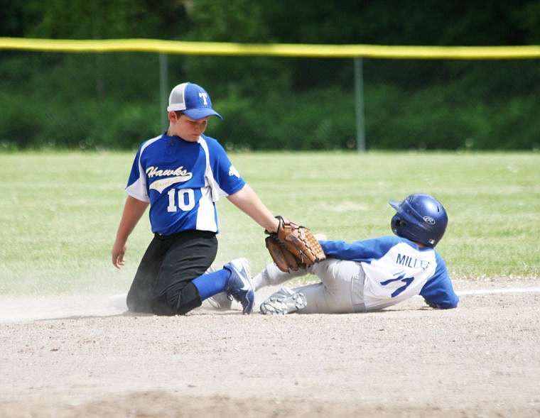 <p>Superior baserunner Issac Miller slides safely into third base, beating the tag by Thompson Falls infielder Bradley Sieben. </p>