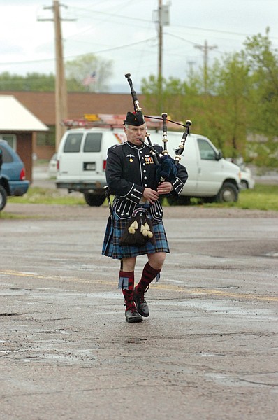 Jim Pettit provides some music from his bagpipe during the parade in Ronan. The clouds and rainy weather didn&#146;t 
prevent the parade participants from performing their best