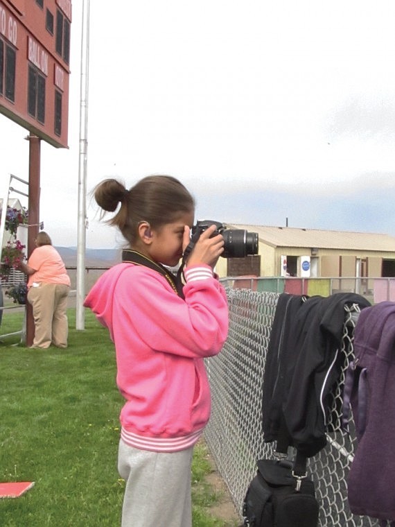 Laura Sandoval, 10, wanted to walk, but her dad, who did walk, gave her the assignment of photographing him and the event.