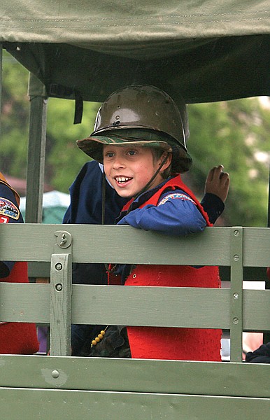 Cub scout Toby Hayes rides with pack 45 in the back of an army truck in the Polson Memorial Day parade.