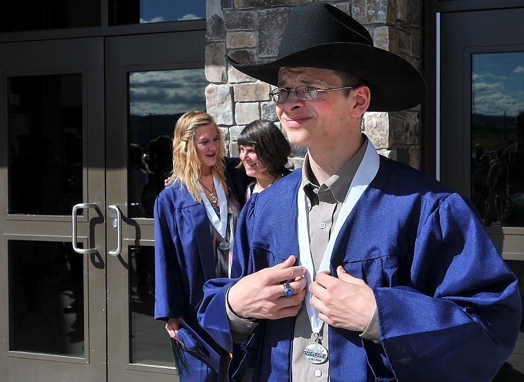 Glacier's James Turner exits the school building, exchanging his graduation cap for a cowboy hat.