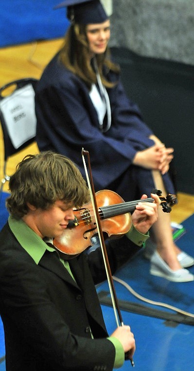 Glacier High Graduating Senior Zach Matteson performs a tune on his violin before a packed gymnasium during Glacier High School's Commencement Ceremony Saturday afternoon.