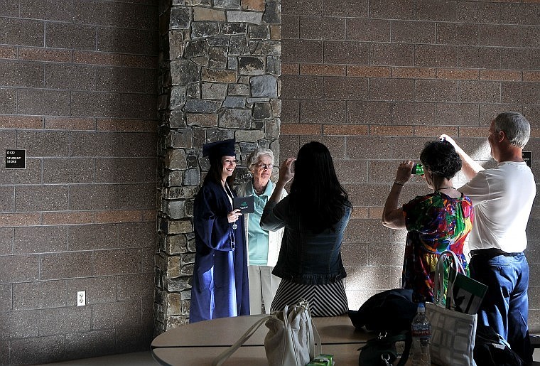 A Glacier graduate poses for photos with family.