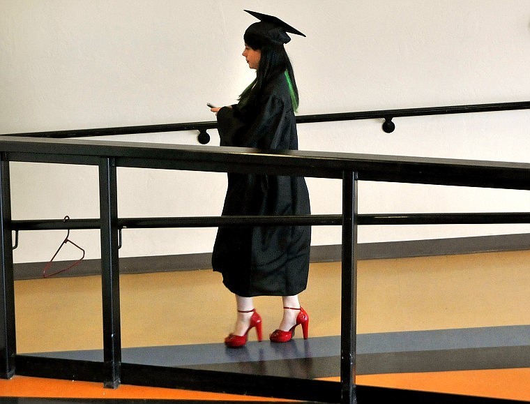 A Flathead Graduating Senior makes her way down the hall to join fellow classmates before the start of the commencement ceremony.