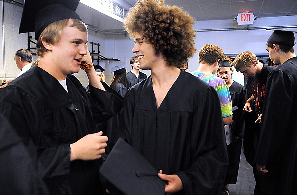 Barret Gosen, left, and Michael Donahue share a laugh as they and other seniors gather before lining up for commencement Saturday afternoon at Flathead High School. Flathead had 302 seniors in its graduating class.