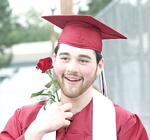 &lt;p&gt;Troy High School's 2012 graduate, Zachary Clark-Hill, adjusts his rose after the conclusion of ceremonies Sunday evening at the Activity Center.&lt;/p&gt;