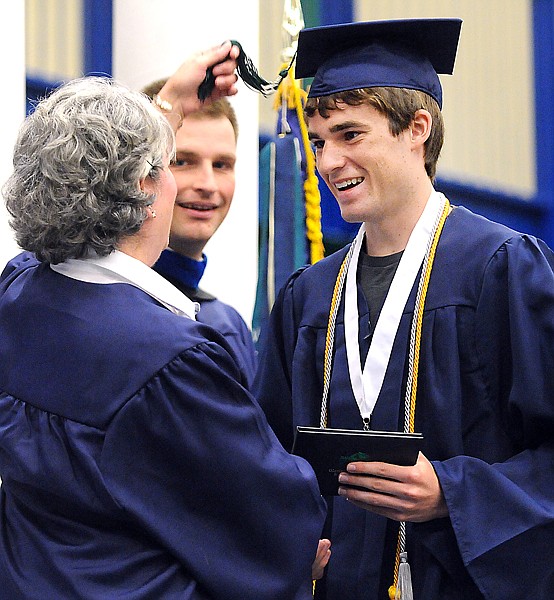 Richard Boyer smiles as he holds his diploma and has his tassel turned during the Commencement Ceremony on Saturday morning at Glacier High School.