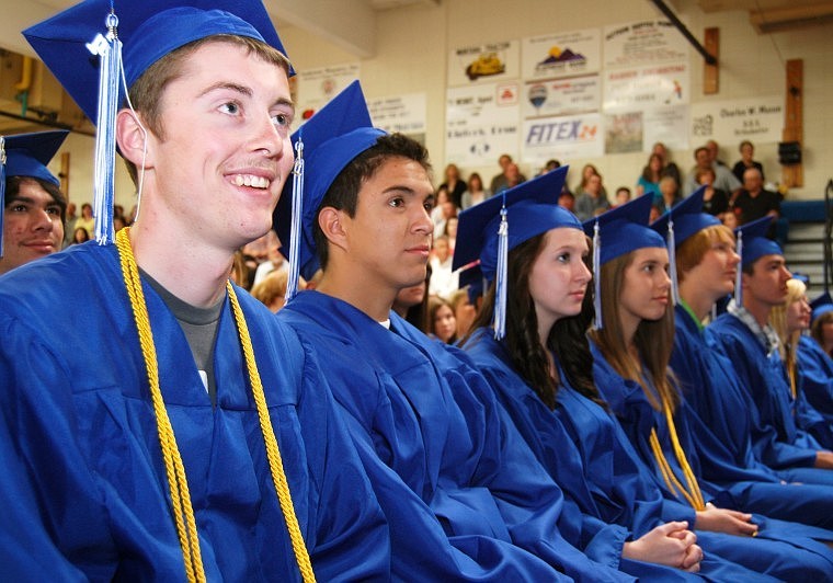 Austin Kelleher (left) and other Bigfork High School seniors listen as principal Matt Jensen introduces the class of 2011. Sixty-nine students graduated Saturday.