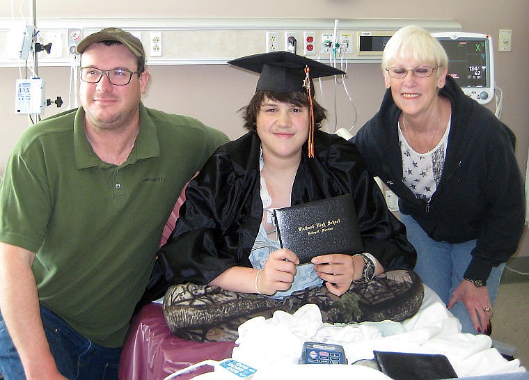 &lt;p&gt;Scottie Smith poses with his diploma and his father, Scott, and grandmother, Ruth.&lt;/p&gt;