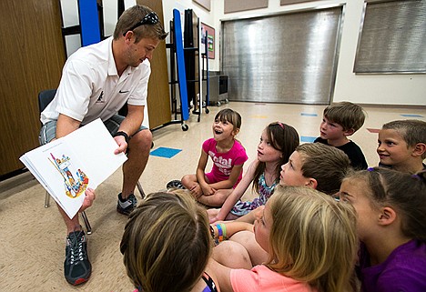 &lt;p&gt;Katlyn Wittenbrock, 7, a first grader at Sorenson Elementary School, smiles as North Idaho College&#146;s Wrestling Coach Keri Stanley starts to read &#147;If You Give a Mouse a Cookie&#148; on Thursday morning. Every year, NIC&#146;s Wrestling Team raises money to buy books for kids to have material to read over the summer.&lt;/p&gt;