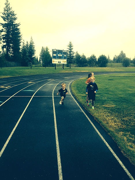 <p>Andy Hotmer, 3, finishing at Run 2 Summer 2014. Big sister, Sydnee, cheers him on.</p>