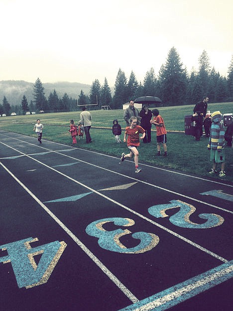 <p>Maia Keith finishes in the 8-10-year-old Run 2 Summer 2014 race.</p>