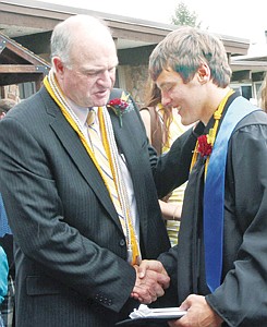 &lt;p&gt;Senior Class President Dylan Berget receives a hearty handshake from Principal Rik Rewerts following graduation ceremonies Sunday.&lt;/p&gt;