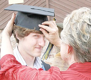 &lt;p&gt;Patty Rambo adjusts Andrew Smith's mortar board.&lt;/p&gt;