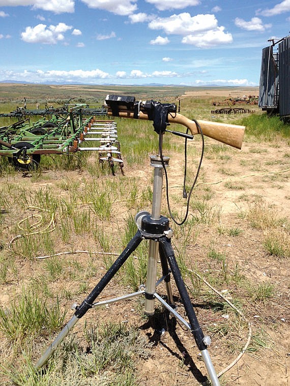 A makeshift laser device mounted to a rifle stock on a tripod
