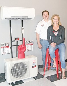 <p>The Sweedmans of Formula Fabrication in their new showroom at 31936 Highway 2. The red No. 1 finger is the award for top in sales in Montana.</p>
