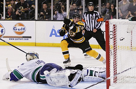 &lt;p&gt;Boston left wing Brad Marchand shoots and scores against Vancouver Canucks goalie Roberto Luongo in the second period during Game 3 of the Stanley Cup Finals on Monday in Boston. The Bruins won 8-1.&lt;/p&gt;