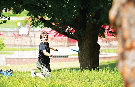 &lt;p&gt;Geoff Carr, Coeur d'Alene, cautiously maneuvers his disk through a group of trees on the second hole at the North Idaho Disc Golf Club Disk Golf league tournament on Cherry Hill on July, 1 2012.&lt;/p&gt;