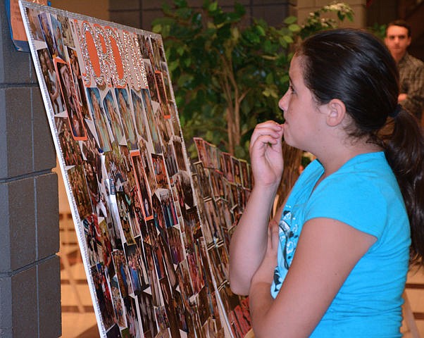 &lt;p&gt;Emilia Kennille, 10, checks out a graduates picture board at the Ronan High School graduation&lt;/p&gt;