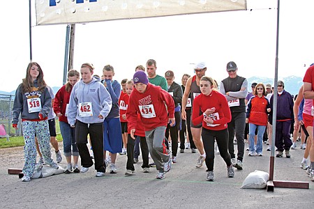 Runners line take off from the starting line of the Alpha Upsilon Torch Scholarship Run at the Polson Softball Fields on Sunday, June 6, 2010.