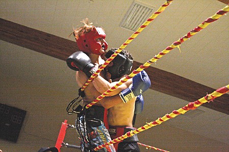 Cameron Neiss, left, of Ronan, and Cole Rice of Arlee,   hit the ropes during the main event on the night. Both are state wrestling champions.