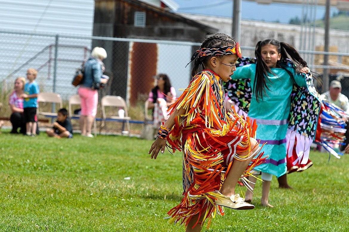 &lt;p&gt;Luky Lefthand, middle, and Aila Butterfly dance with a during a powwow at Cherry Valley Elementary School on June 1.&lt;/p&gt;