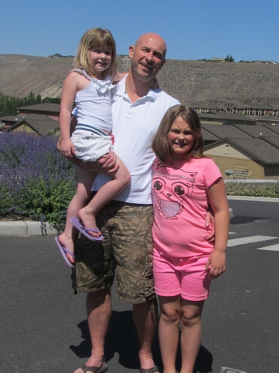 Andrew MacGillivray spends a lot of quality time with his daughters Emma and Sinclair (in his arm) when he's home at Sunserra. A world traveler, MacGillivray finds Crescent Bar to be one of the most beautiful places he's been.