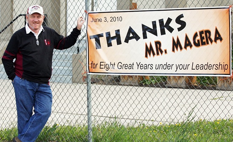 Richard Magera stands next to a sign showing him appreciation for eight years as Plains superintendent.