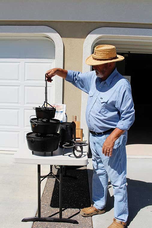 Ted De Witt shows off a few of his Dutch ovens and tools for using them. The Columbia Basin Dutch Oven Society will have a booth at the Moses Lake Farmers Market June 21.