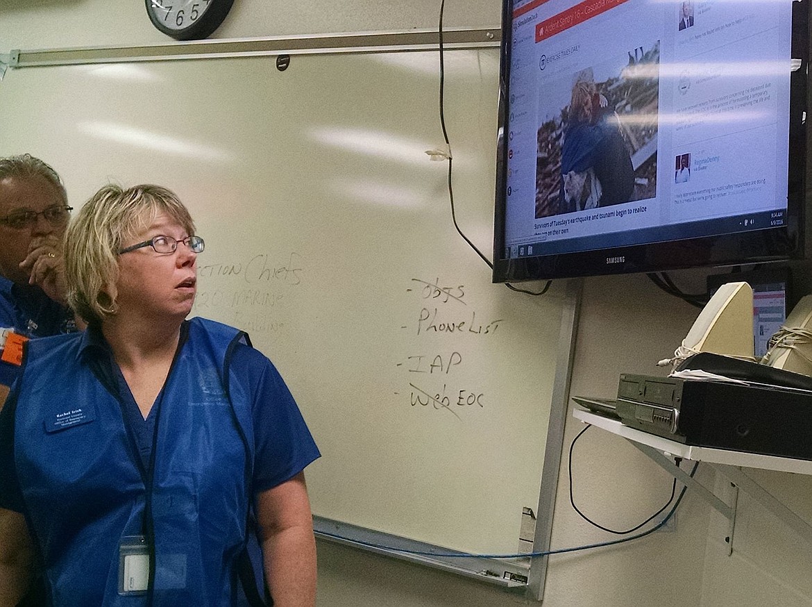 &lt;p&gt;Rachel Irish, who works for Kootenai County's Office of Emergency Management, checks out updates of the West Coast tsunami during an emergency operations center drill on Thursday at the Kootenai County Sheriff's Office.&lt;/p&gt;