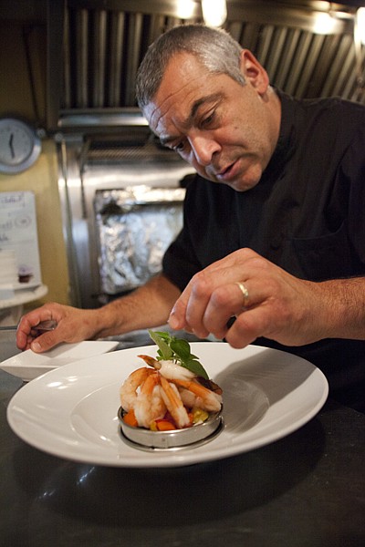 <p>Mosaic restaurant owner, Marc Guizol, puts his finishing touch on the Saffron Scented Risotto and Shrimp, in Bigfork on Thursday, June 7. The Saffron Scented Risotto and Shrimp is one of a few items from Marc and Caroline Guizols previous restaurant, La Provence.</p>
