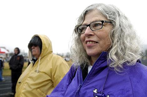 MaryAlice Thomas stands in the rain next to her husband, Polson girls track coach bruce Thomas during a track meet this spring in Columbia Falls. Thomas supported her husband's coaching career for over 20 years. Jennifer DeMonte/Daily Inter Lake