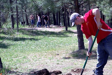 &lt;p&gt;North Idaho Disc Golf Club President Ben Squires digs out an old basket location while a team of volunteers prepares the new tee for Hole 12.&lt;/p&gt;