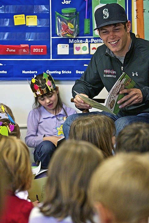 &lt;p&gt;JEROME A. POLLOS/Press Jake Mason, a North Idaho College wrestler, reads to first-grade students at Sorensen Elementary during a Shirley Parker Reading Program session Wednesday.&lt;/p&gt;