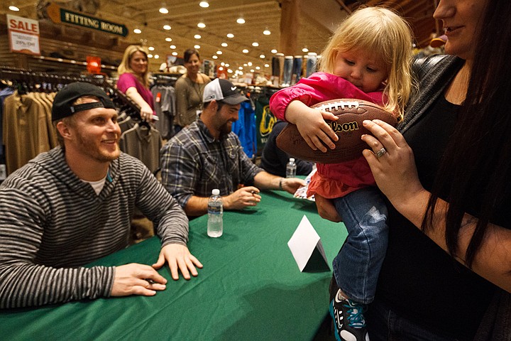 &lt;p&gt;SHAWN GUST/Press Taylin Martin, 2, of Coeur d'Alene, tucks a football under her arm after having it signed by Seattle Seahawk Matt McCoy Thursday at Cabela's in Post Falls. A panel of National Football League players were on hand to sign autographs as part of the Michael Roos Foundation Fish and Chip fishing and gold tournament to benefit area Boys and Girls clubs.&lt;/p&gt;