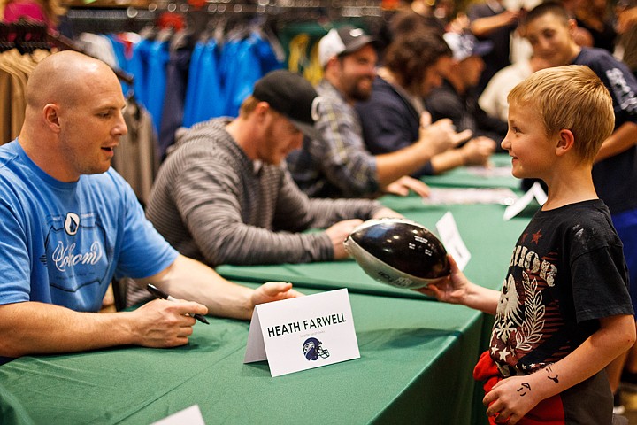 &lt;p&gt;SHAWN GUST/Press Colton Hayes, 7, excitedly hands off his football to Seahawk linebacker Heath Farwell for a signature.&lt;/p&gt;