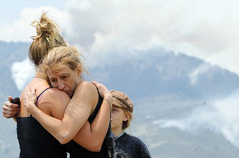 &lt;p&gt;Tracy Greenwood embraces her daughter, Mariah Greenwood, as they watch the High Park wildfire burn near their home west of Fort Collins, Colo., on Monday, June 11, 2012. The fire grew to more than 31 square miles within about a day after being reported. It has destroyed or damaged 18 structures and smoke has drifted as far away as central Nebraska, western Kansas and Texas. (AP Photo/Ed Andrieski)&lt;/p&gt;