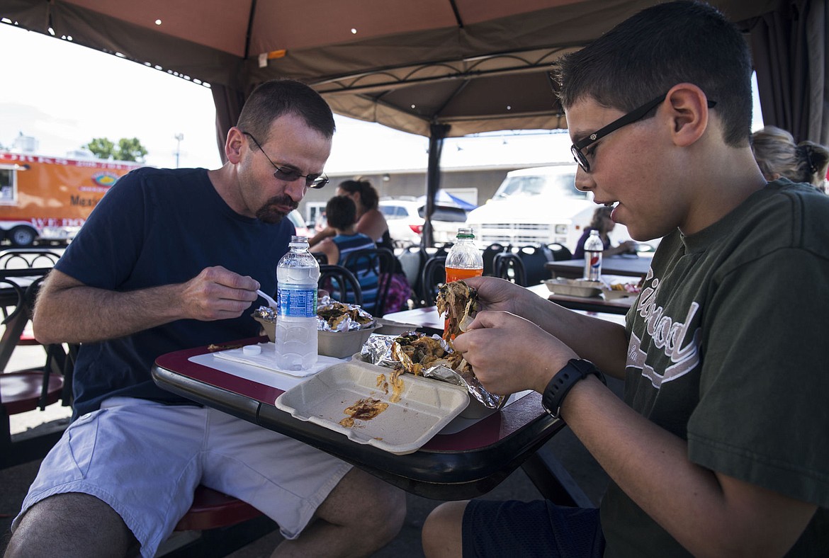 &lt;p&gt;LOREN BENOIT/Press Brian Stewart and his son Ian, 12, of Hayden, enjoy a box of Backhills Barbecue nachos at The Best Food Court on Saturday, June 4, 2016.&lt;/p&gt;