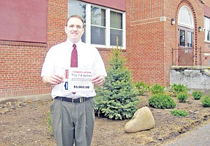 &lt;p&gt;Troy High School principal Jacob Francom holds a certificate indicating his $5.000 grant.&lt;/p&gt;