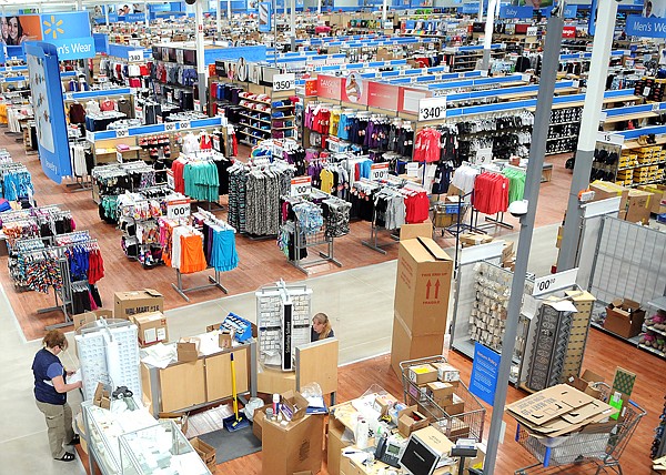 Employees work to unpack and stock merchandise on Friday at the new Walmart in Kalispell.