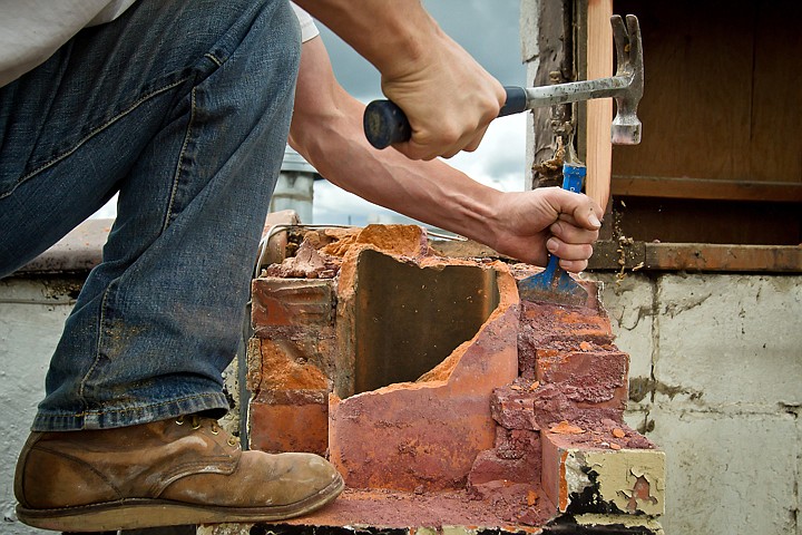 &lt;p&gt;Tony Martin chips away at old motor while separating bricks on a chimney Wednesday atop the old Chelsea Bar in Coeur d'Alene.&lt;/p&gt;