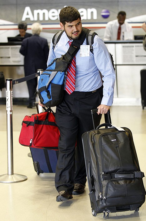 &lt;p&gt;Christian Noriega of Hayward Calif., takes his checked bags to security drop off at the Philadelphia International Airport Monday in Philadelphia.&lt;/p&gt;