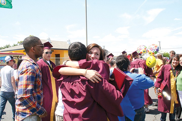 Graduates Emily Hudson and Fabrizio B. Delgado share a hug after Moses Lake High School's graduation ceremony Saturday.