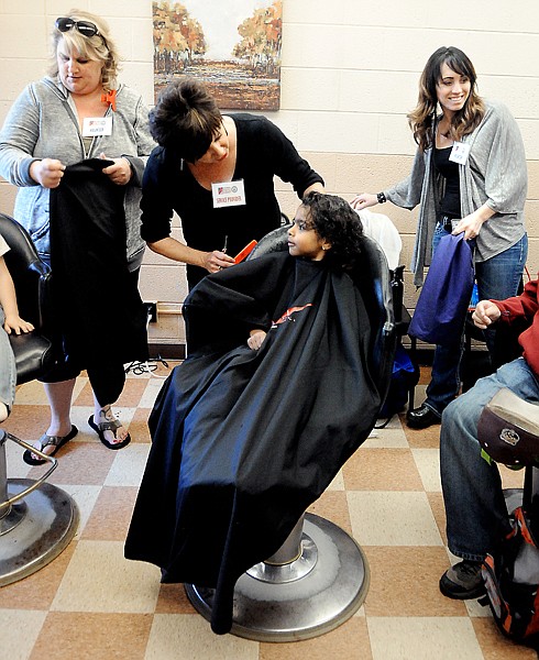 &lt;p&gt;Joseph Berg, 5, gets his hair cut by Jacarla Corne of Protege Salon at the Homeless Connect event on Thursday morning, June 6, at Samaritan House in Kalispell. On the left is Janell Malczynski of Hair Tech and at right is Jesi Schuman of Salon Jazlin.&lt;/p&gt;