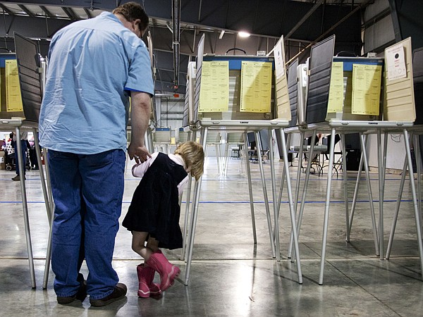 &lt;p&gt;Tim Sievers votes with his 3-year-old daughter, Arabella, at the Flathead County Fairgrounds on Tuesday. Sievers said it is important for his daughter to see him fulfill his civic duty, with the hopes that she will learn from the experience.&lt;/p&gt;